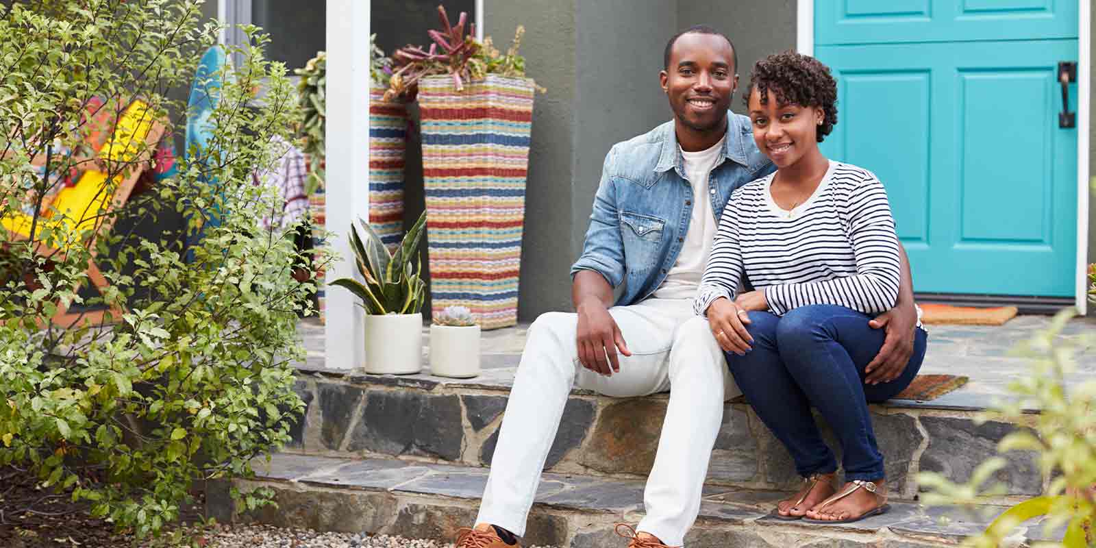 couple outside their home with second home insurance