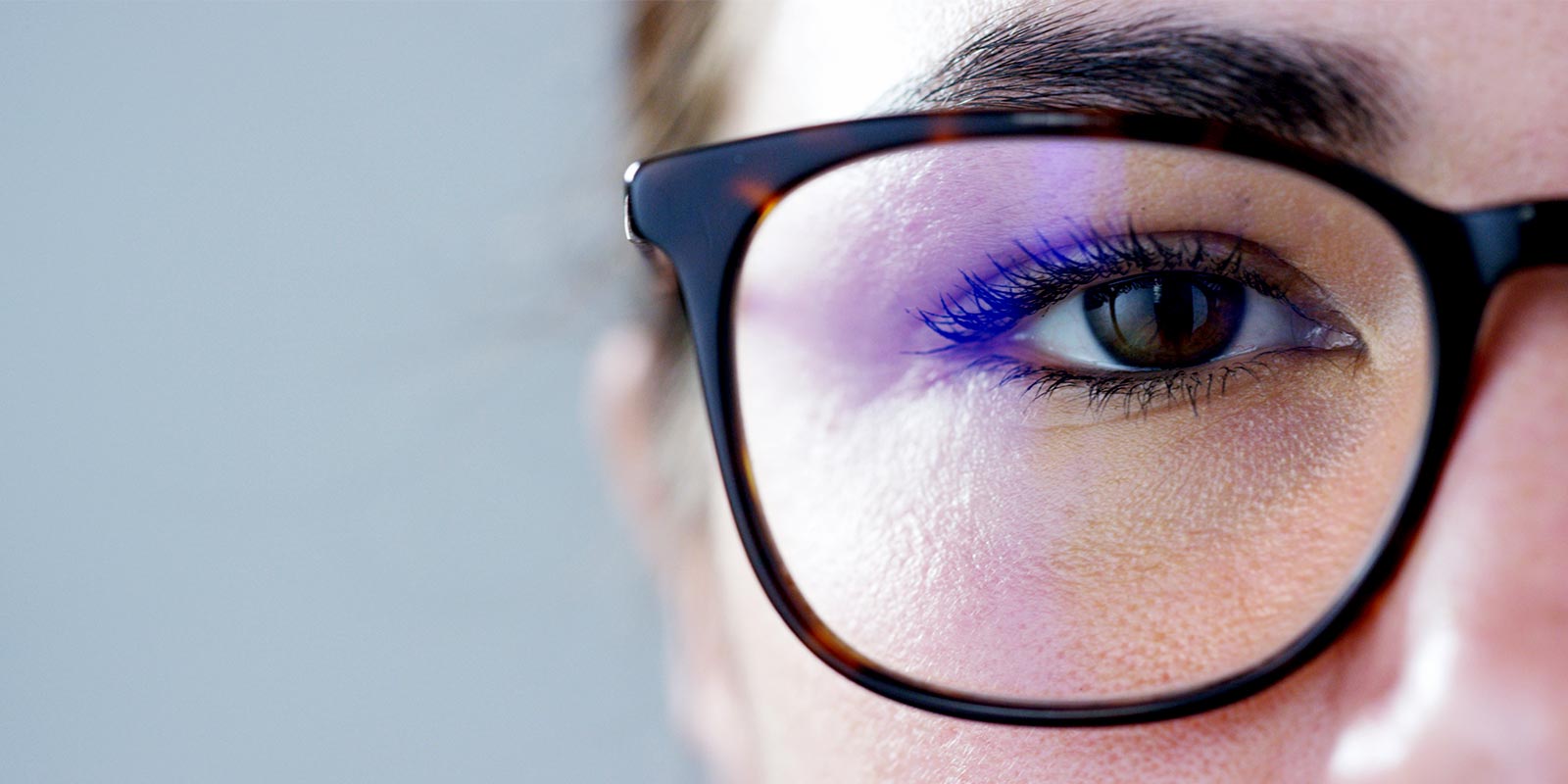 a close up look at a women with glasses