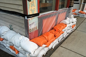 a store front surrounded by sand bags to protect from the water