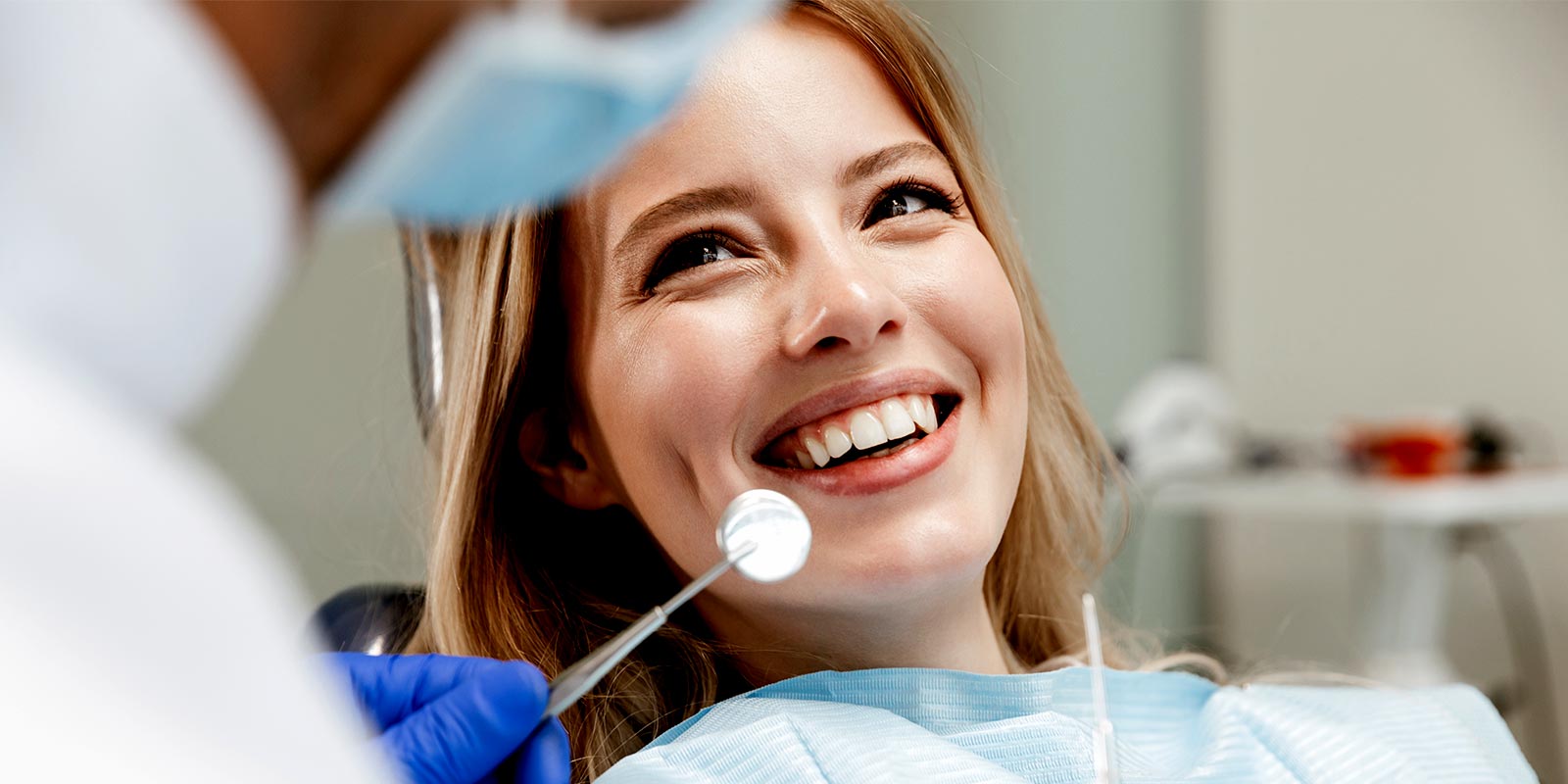a women visiting a dentist with personal dental insurance