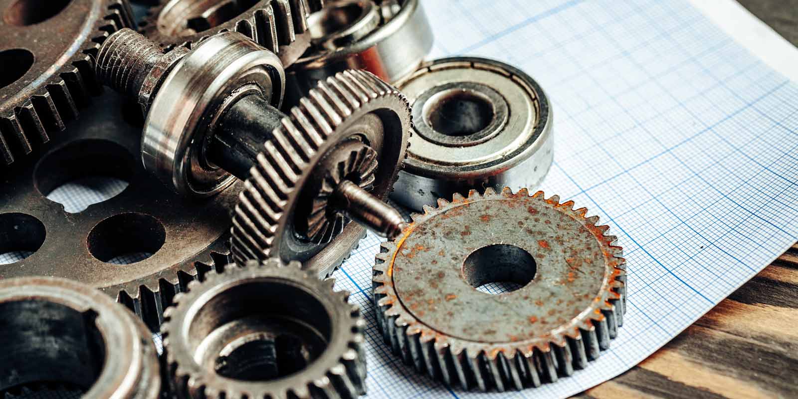 gears on a sheet of graph paper representing equipment breakdown insurance
