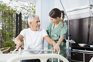 a elderly man getting help by a nurse in a long term care facility