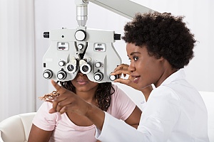 a woman getting her annual eye exam with vision insurance