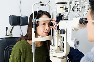 a women getting her vision checked with vision insurance