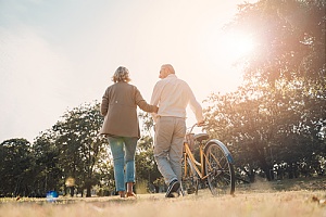 an older couple taking a walk at a park covered with whole life insurance