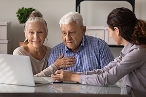an older couple taking to a banker about their retirement savings