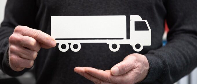 man holding a paper truck