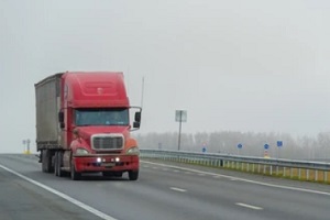 red commercial truck in highway