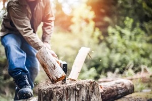 man cutting wood logs