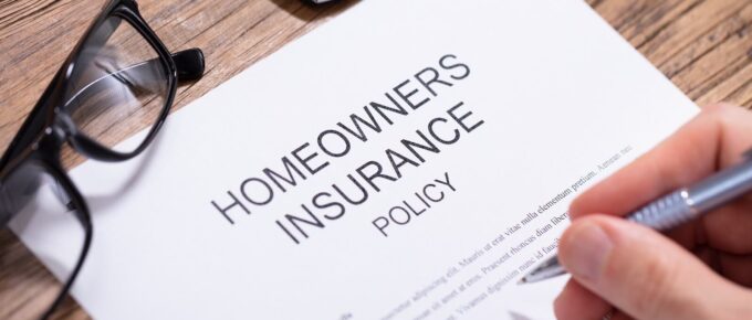 person filling homeowners insurance policy form