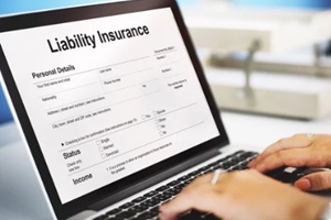 man filling liability insurance form