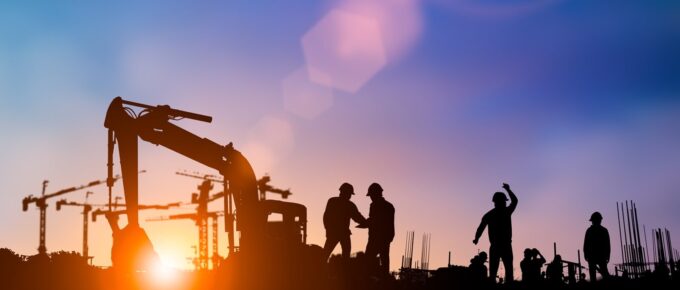 silhouette of engineer and construction team working at site over blurred background for industry background with light fair