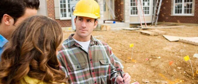 contactor reviewing home builder plans with the homeowners