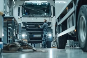 mechanic servicing a commercial vehicle in a garage