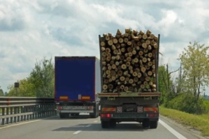 big logging truck passing another truck