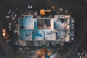 aerial birds eye image of the frame of a house being built on a construction site at sunset