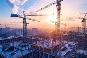 construction site bustling with activity, cranes towering overhead, symbolizing progress and development