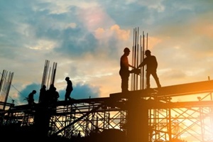 silhouette of engineer and construction team working at site over blurred background sunset pastel for industry background