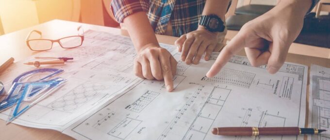 asian engineer pointing equipment architects On the desk with a blueprint in the office