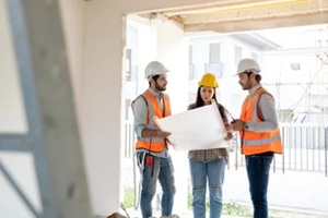 engineers and architect discussion for plans for new home and working on a building site