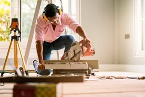 smart indian contractor hand use sawing machine wood work house renovation background home improvement ideas concept