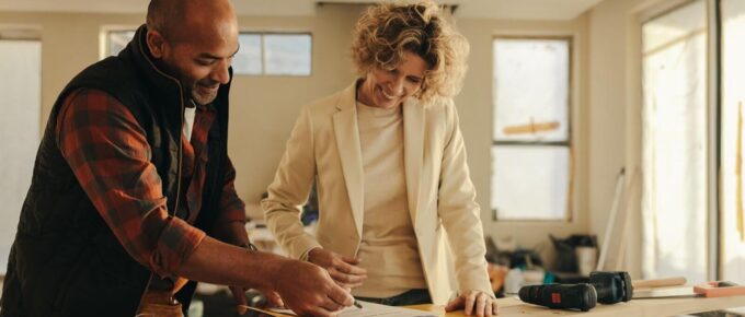 home renovation professional signing a contract with a homeowner