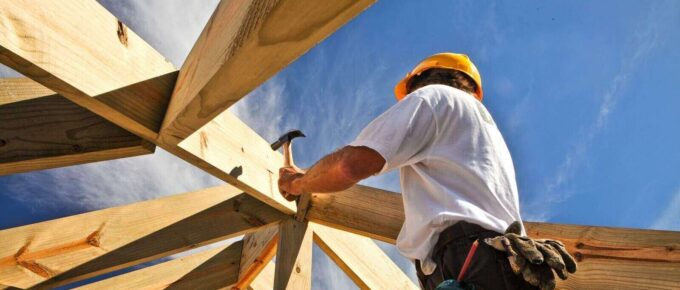 roofer ,carpenter working on roof structure at construction site