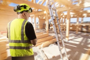 man construction worker is constructing building from planks