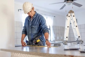 measurement and handyman doing home repair, renovation and building a counter