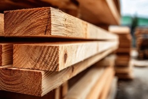freshly cut and neatly stacked dimensional lumber planks at a timber yard or sawmill