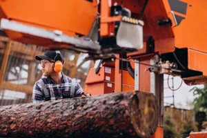carpenter working on a sawmill on a wood manufacture