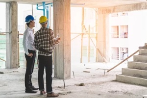 asian contractor and engineer inspecting material in construction building