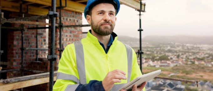 man, thinking and construction worker on site with tablet for email feedback on renovation